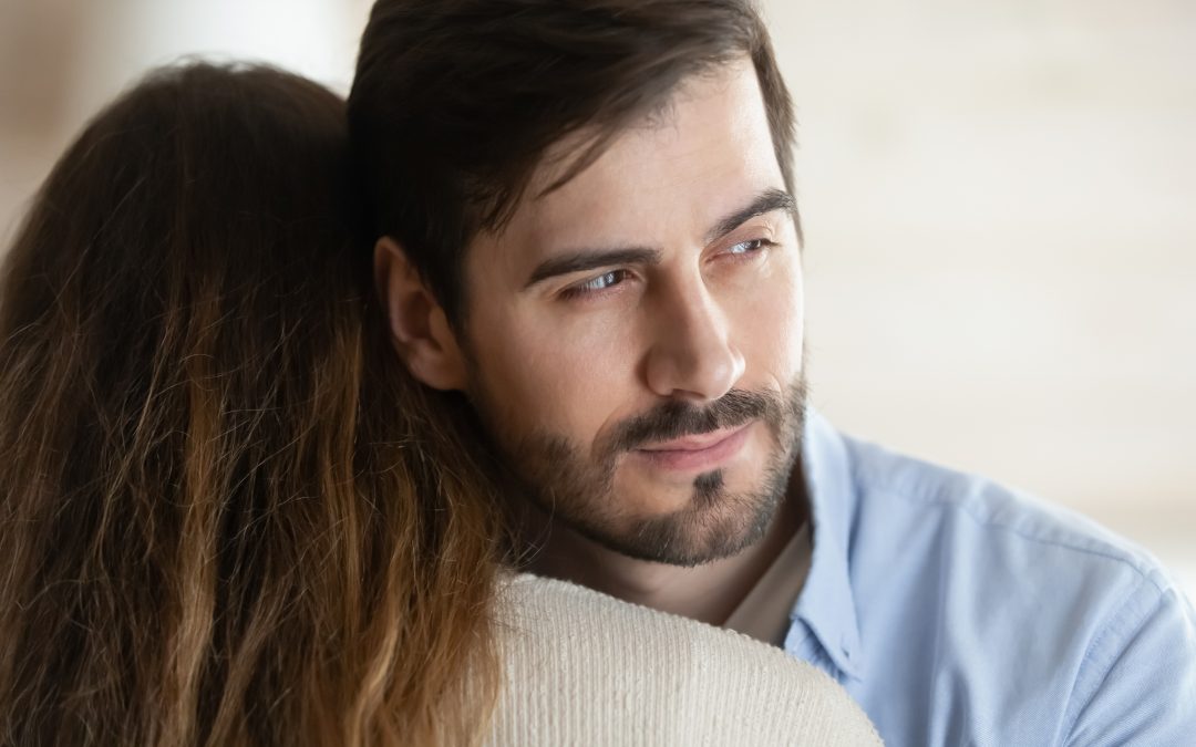 Thoughtful young man hug girlfriend or wife look in distance thinking pondering about relationship problems, millennial male liar or cheater make peace with beloved woman, fake forgiveness